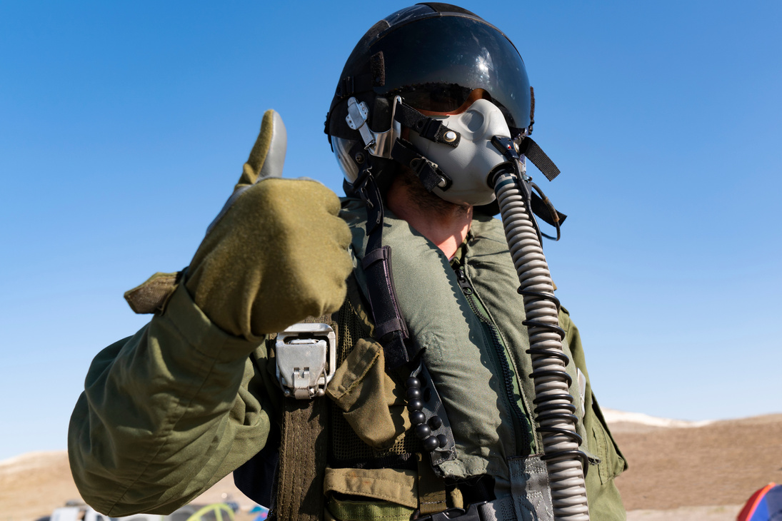 Pilot with suit and military air. Fighter pilot portrait posing